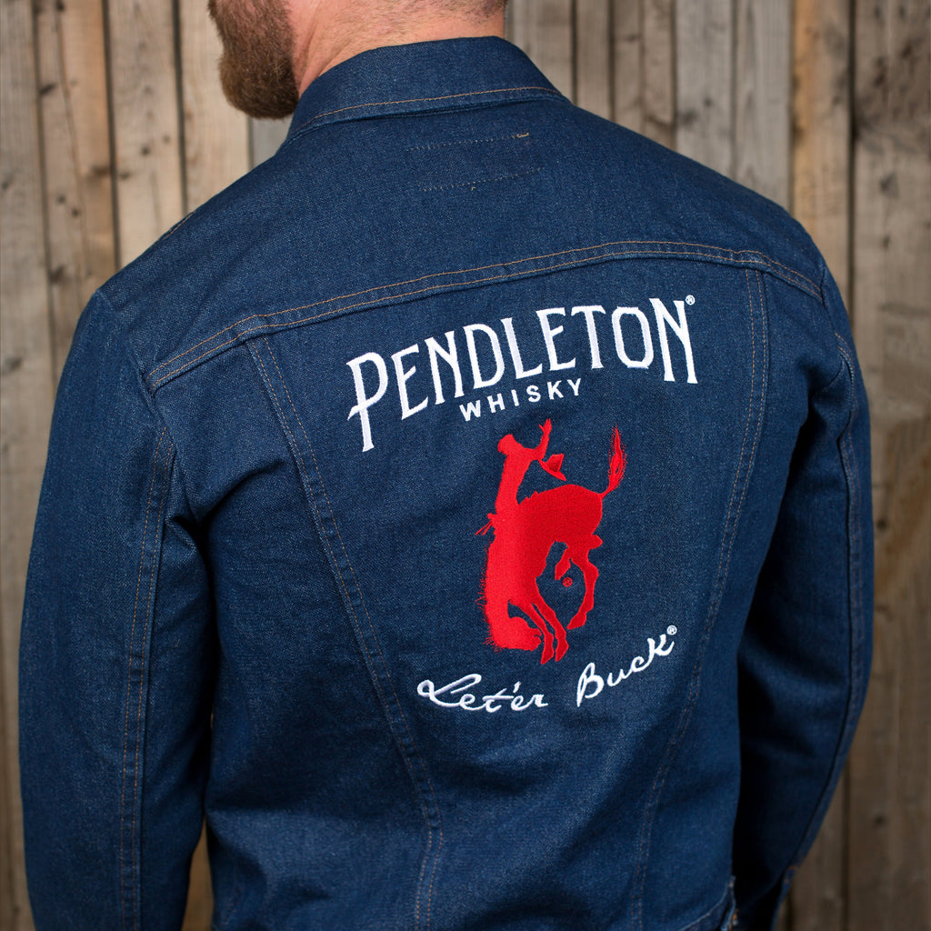 Back view of a man wearing a Wrangler Denim Jacket with the Pendleton®️ Whisky logo embroidered on the pack panel 