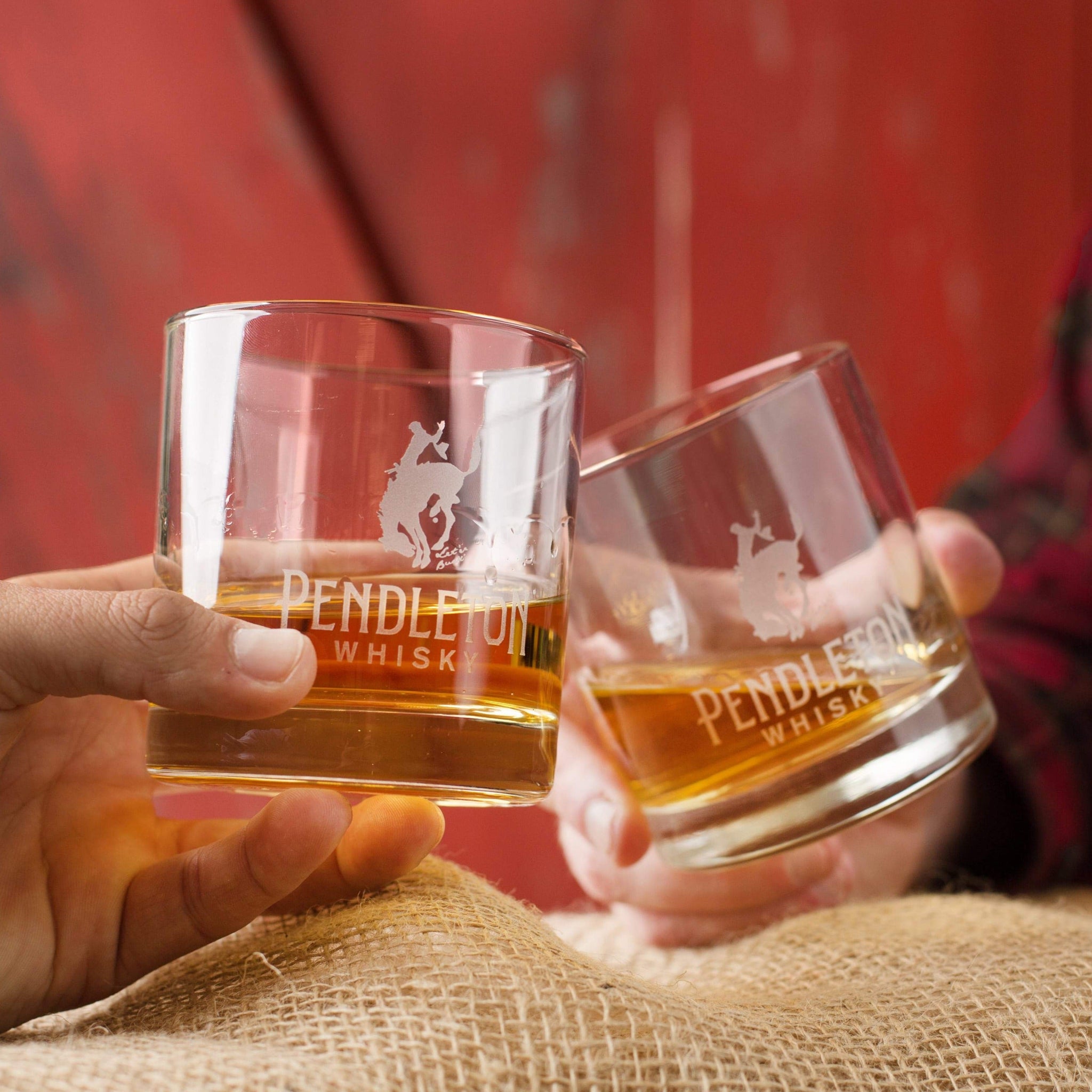 Logo etched rocks glasses cheersing