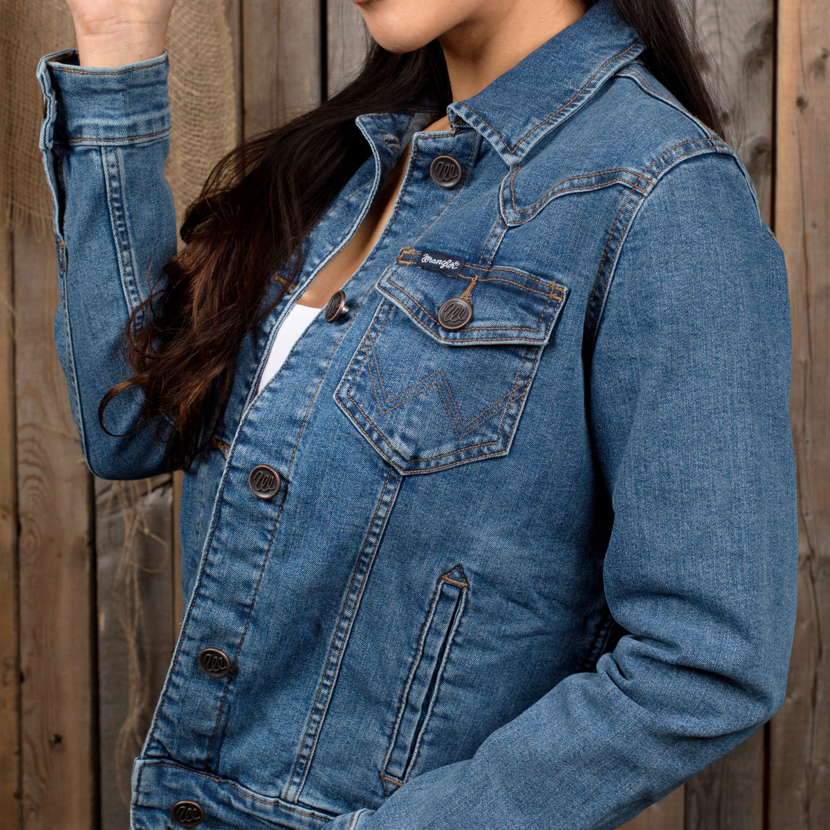 Side view of a woman wearing a Wrangler Denim Jacket