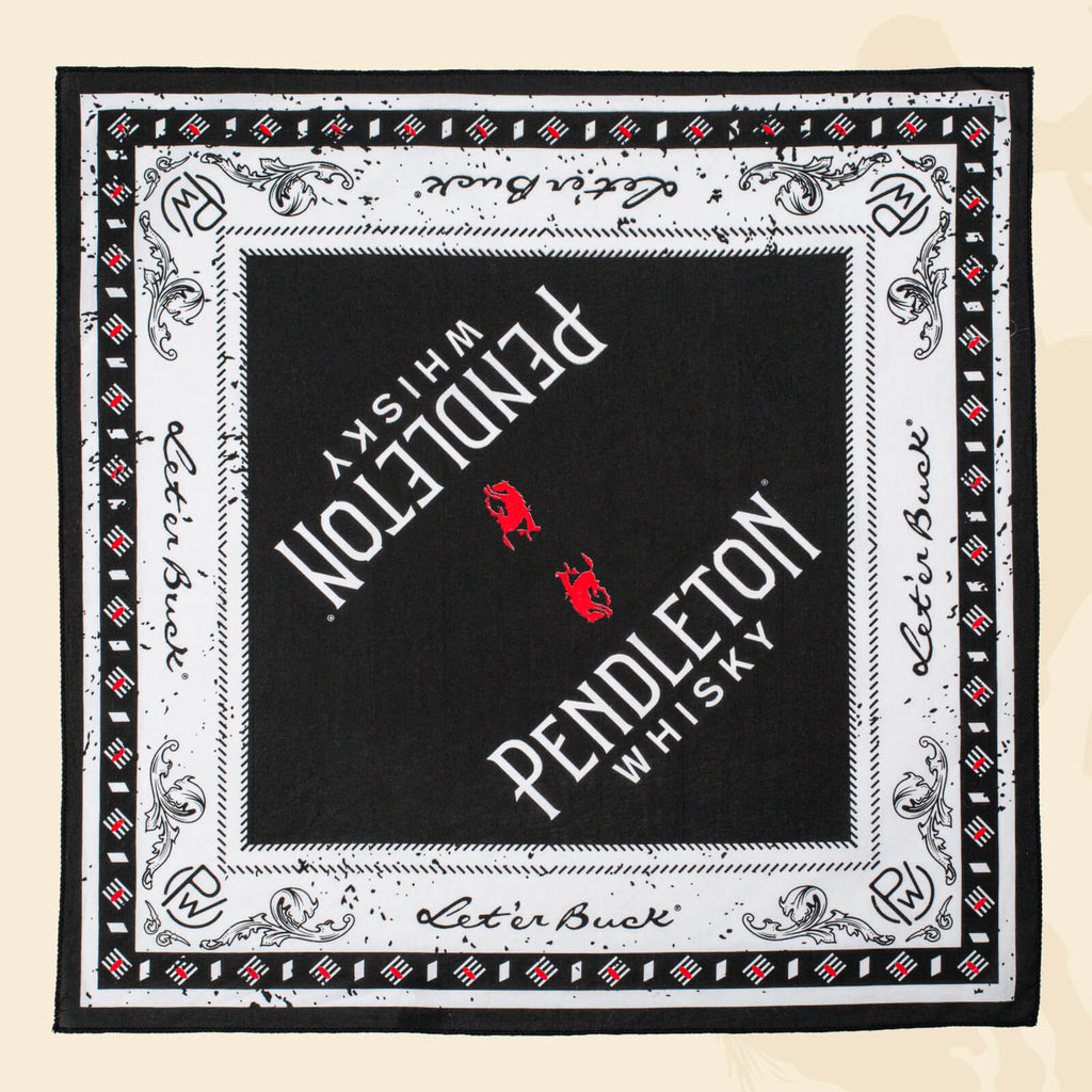 Flatlay of black, red, and white patterned Pendleton® Whisky Bandana on cream surface