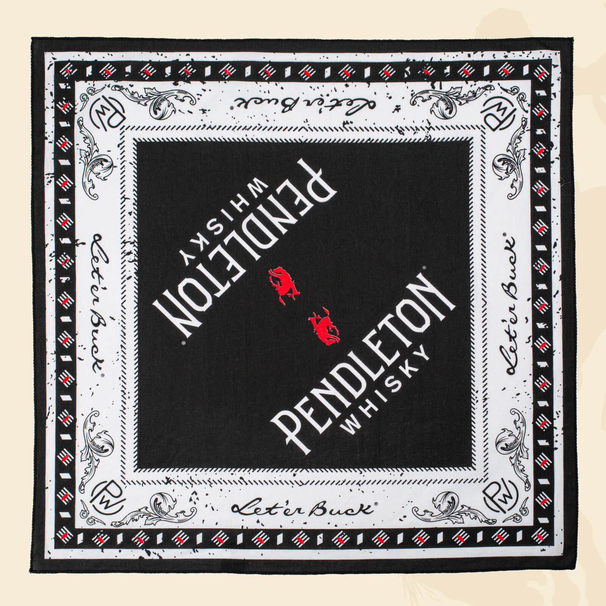 Flatlay of black, red, and white patterned Pendleton® Whisky Bandana on cream surface