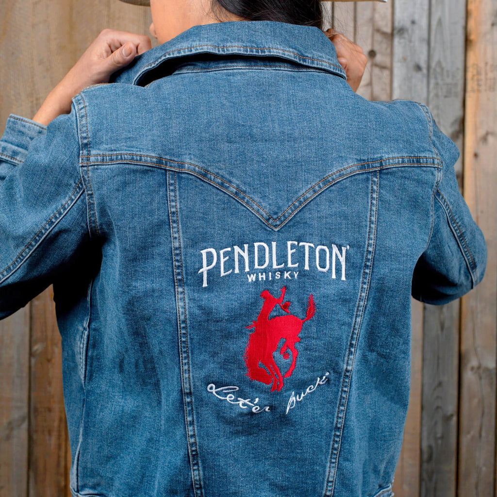 Woman wearing Wrangler Denim Jacket with embroidered Pendleton® Whisky logo