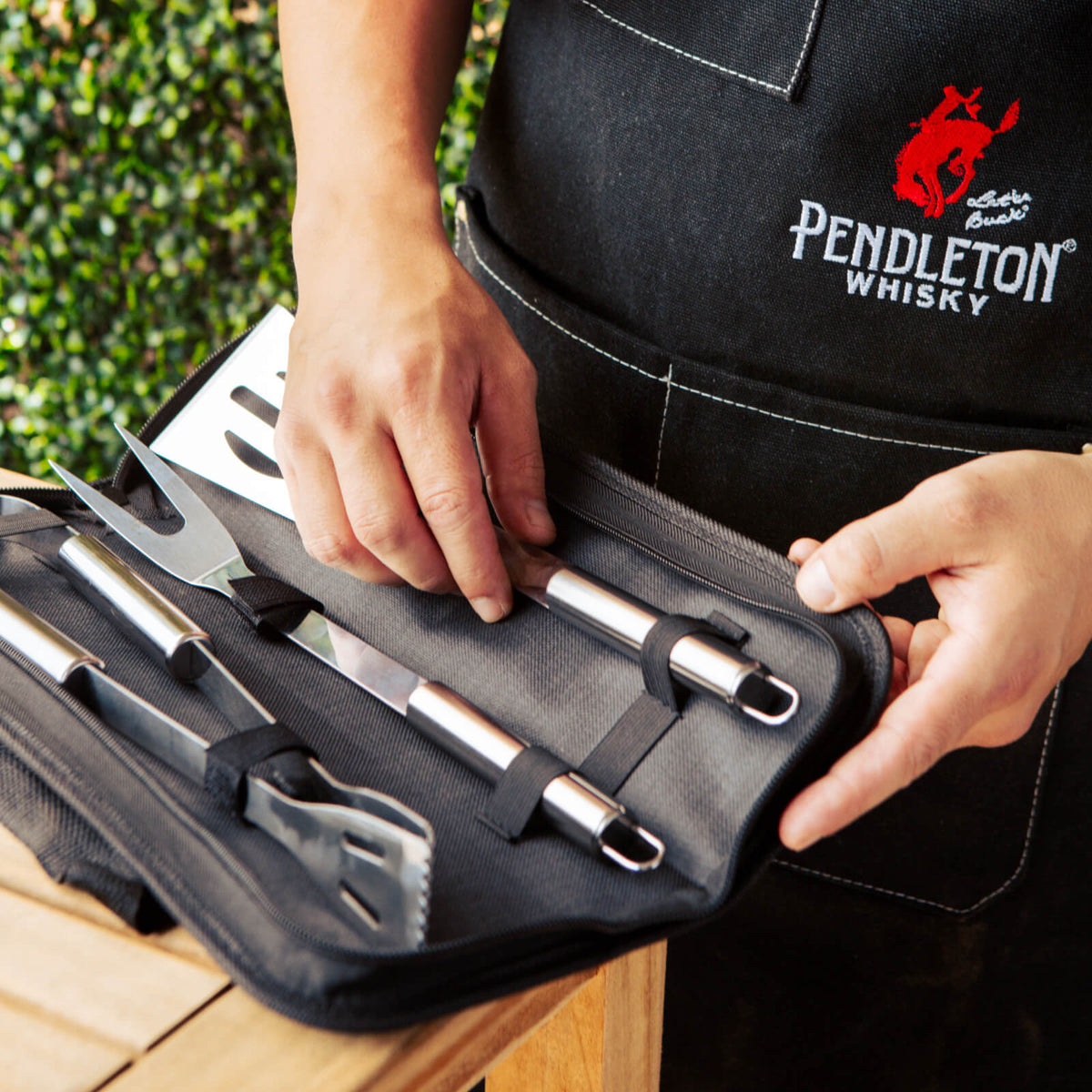 Black canvas apron and deluxe BBQ grilling kit