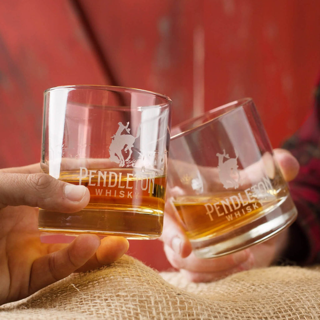 Logo etched rocks glasses cheersing