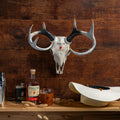 Pendleton Whisky Deer Skull with a whisky flask, highball glasses and bottle of Pendleton Whisky next to a cowboy hat