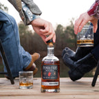 A bottle of Pendleton Whisky Midnight enjoyed by a cowboy and cowgirl